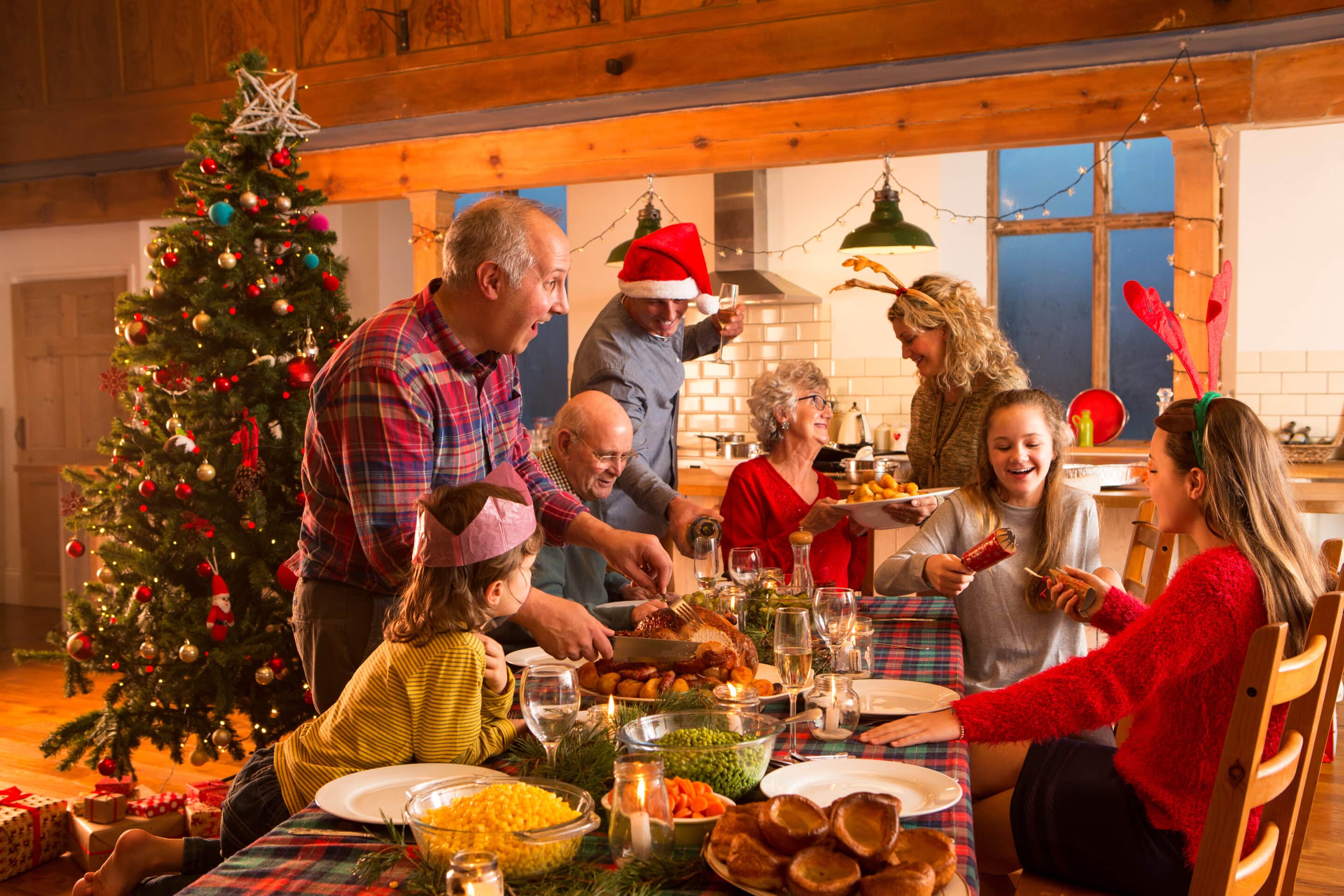 Family & friends gathered around Christmas dinner table enjoy consistent waster pressure