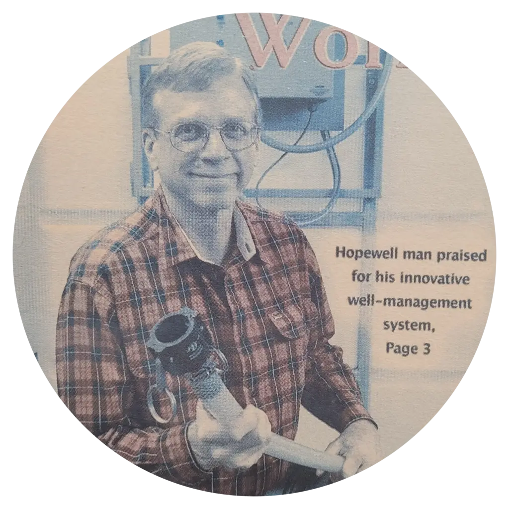 Andy Reid on a newspaper clipping, showing off his invention of the Well Manager® System